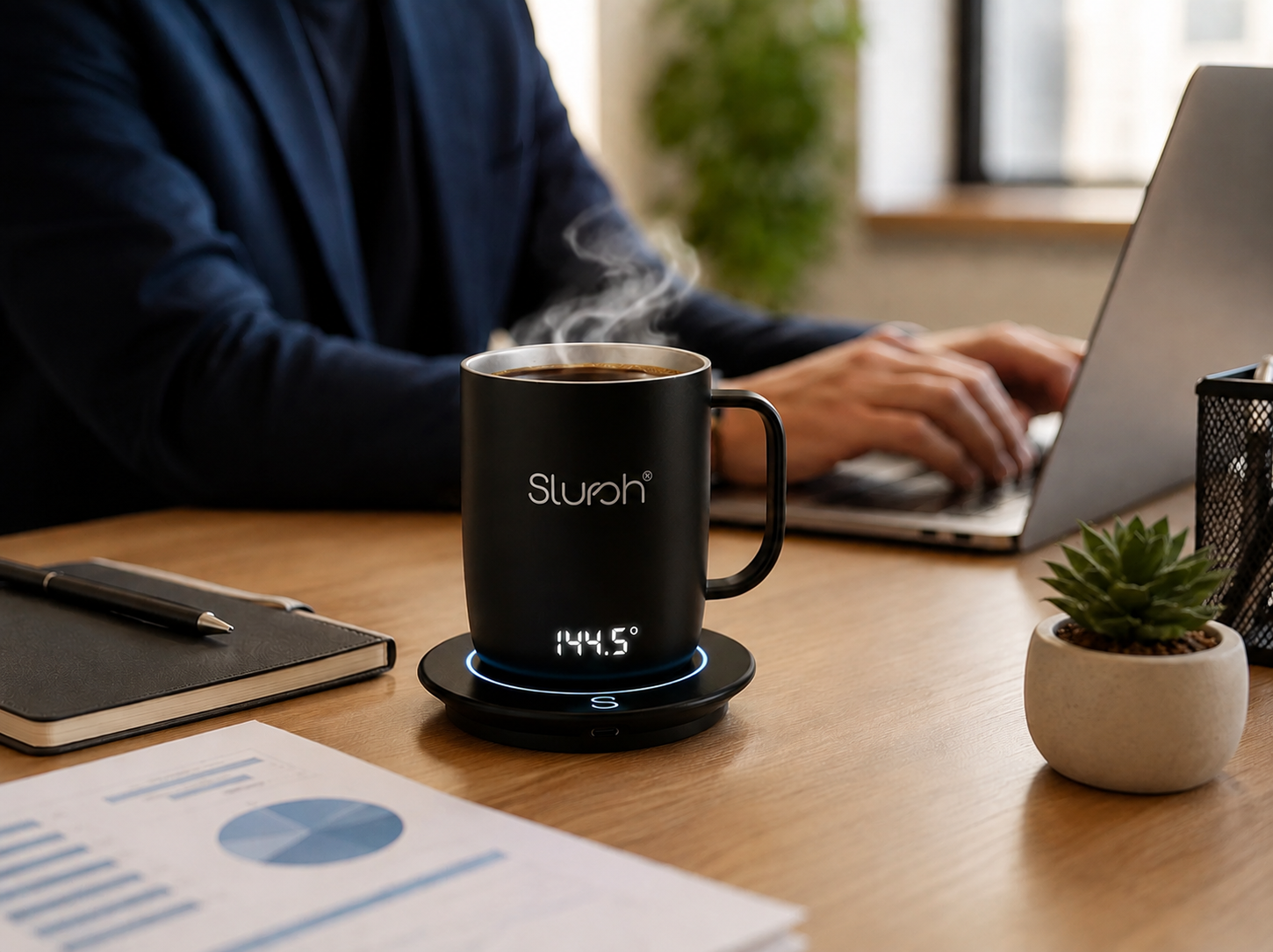 Remote work setup with the Slursh Smart Mug beside a laptop